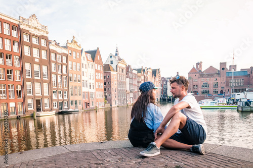 Happy young couple at waterfront at the canals of Amsterdam