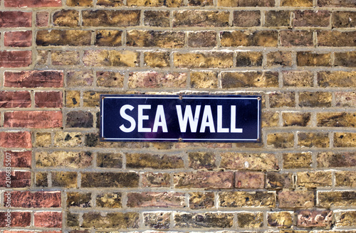 Sea Wall Road Sign on Brick Wall