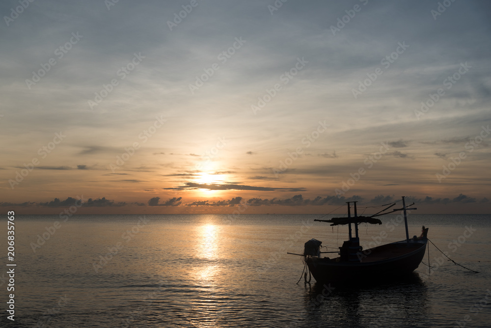 Fishing boat on the beach in the morning with sun rise.