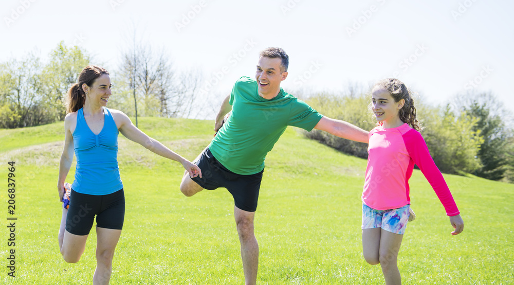 Parents with children sstretching together outside Parents with children sstretching together outside