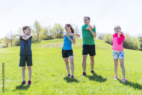 Parents with children sport running together outside