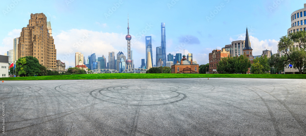 Empty asphalt square and modern city architecture in Shanghai at sunset