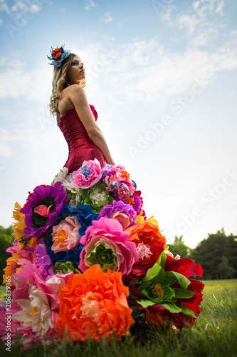 Young woman in an unusual skirt of flowers