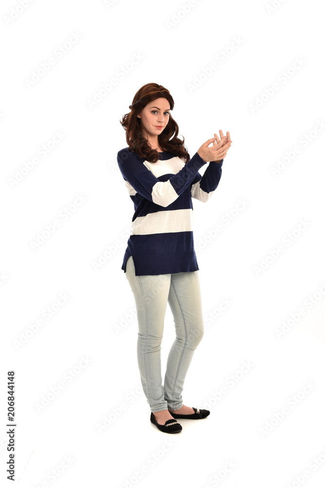full length portrait of girl wearing striped blue and white jumper and jeans. standing pose on white studio background full length portrait of girl wearing striped blue and white jumper and jeans. standing pose on white studio background