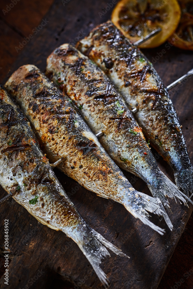 Grilled fish on metal skewers in close-up