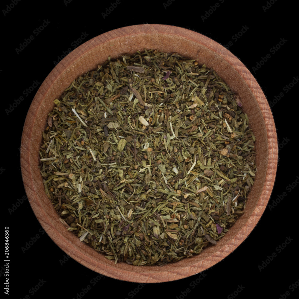 dried sage in wooden cup isolated on black. top view