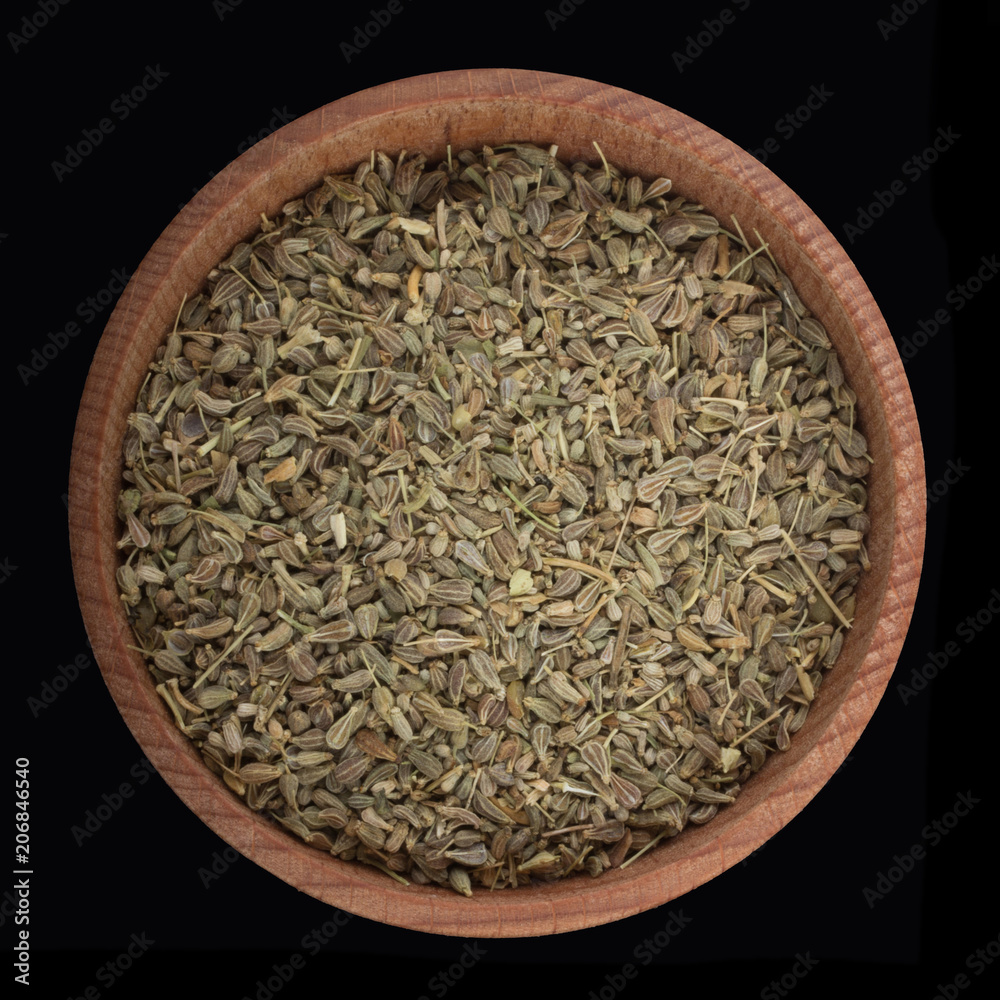 anise in wooden cup isolated on black. top view anise in wooden cup isolated on black. top view
