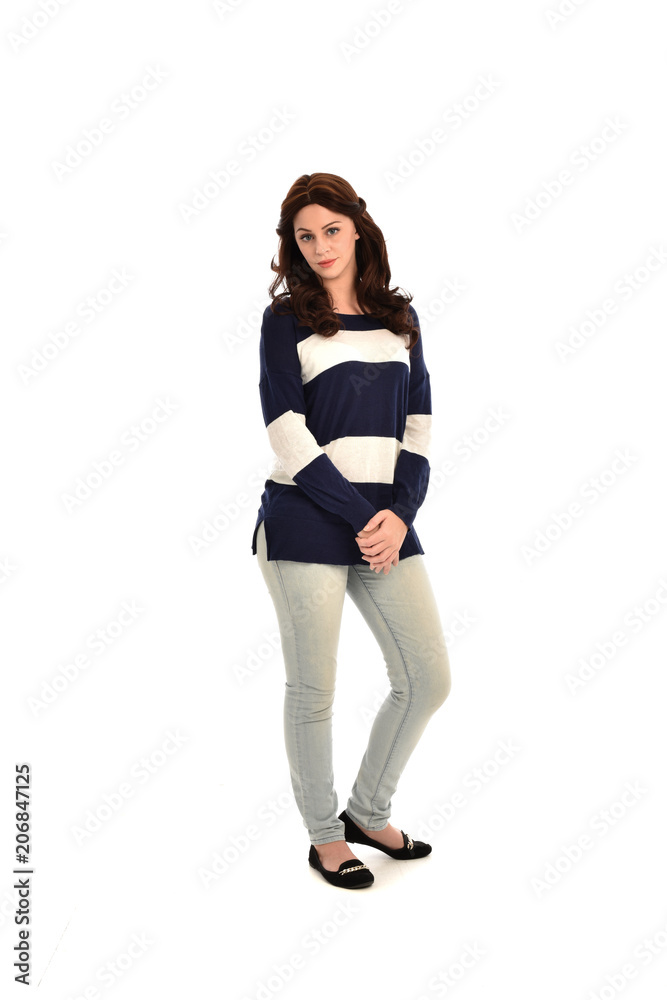full length portrait of girl wearing striped blue and white jumper and jeans. standing pose on white studio background full length portrait of girl wearing striped blue and white jumper and jeans. standing pose on white studio background