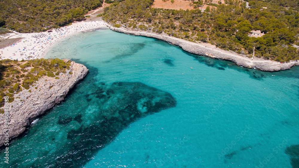 Marvelous aerial drone view of beautiful turquoise sea bay with white sand beach. Mallorca, Spain