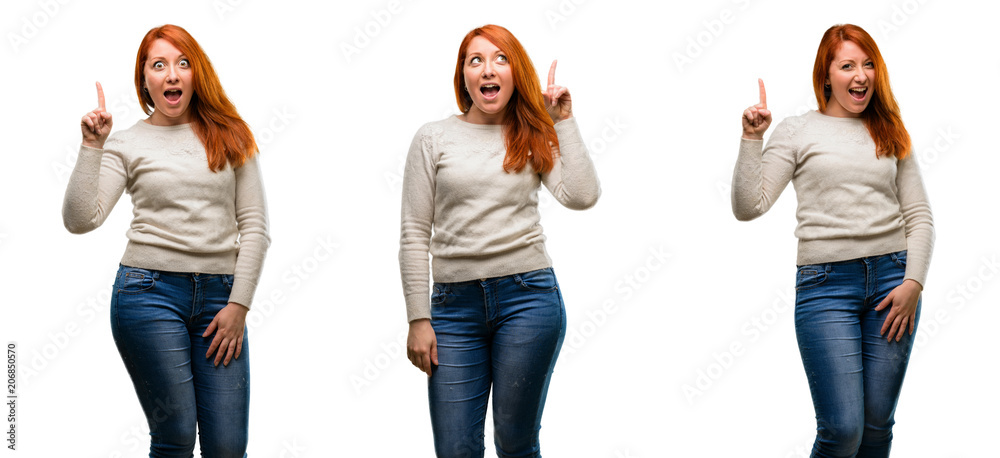 Young Beautiful redhead woman pointing away side with finger