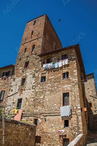 View of old building with clothes hanging to dry in Colle di Val d Elsa. A graceful village with its historic center preserved and known by its crystal production. Located in the Tuscany region  photo