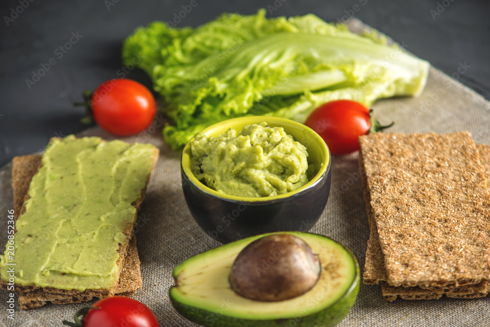 Mexican cold appetizer made of pureed avocado pulp with bread and vegetables. Concept healthy vegetarian Breakfast Mexican cold appetizer made of pureed avocado pulp with bread and vegetables. Concept healthy vegetarian Breakfast