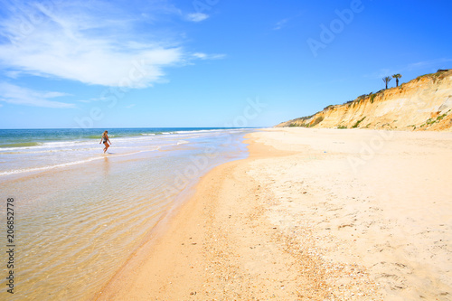 Young lady enjoys the sand beach south of Huelva, Atlantic coast, Andalusia, Costa de la Luz, Spain