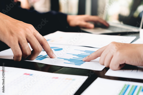 Close up of Business partners discussing financial documents at office