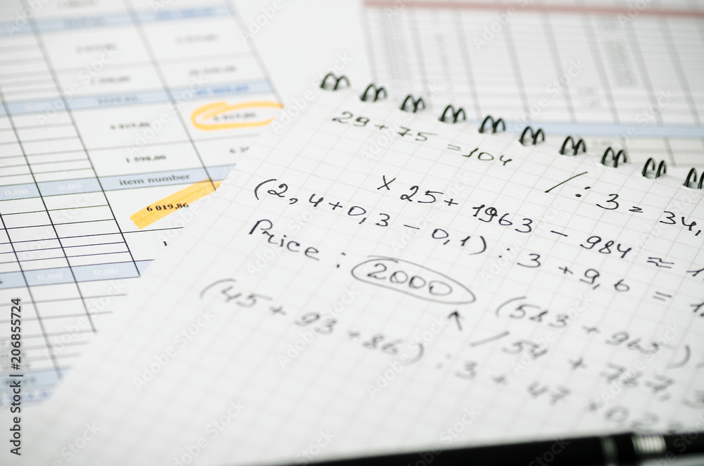 A paper notebook with financial records on the background of tables A paper notebook with financial records on the background of tables