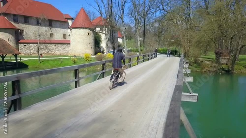 Wallpaper Mural A young man rides his bike towards two pedestrians who are about to start walking across the bridge. Torontodigital.ca