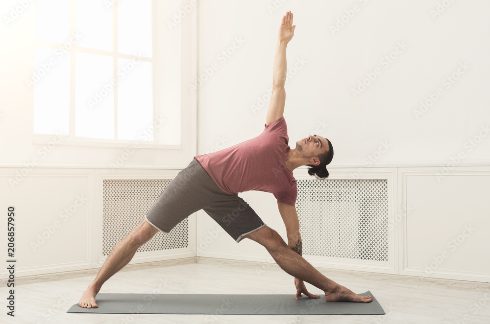 Fototapeta premium Man stretching hands and legs at gym