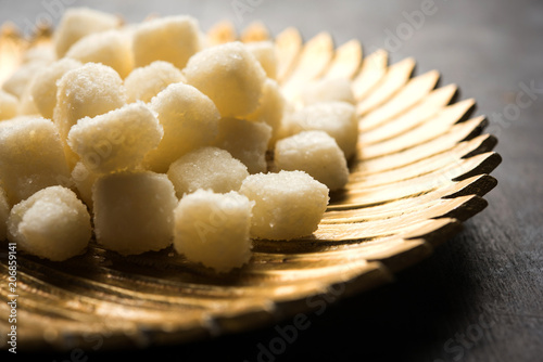 Chena Murki is indian sweet food served in ceramic bowl over moody background. selective focus photo