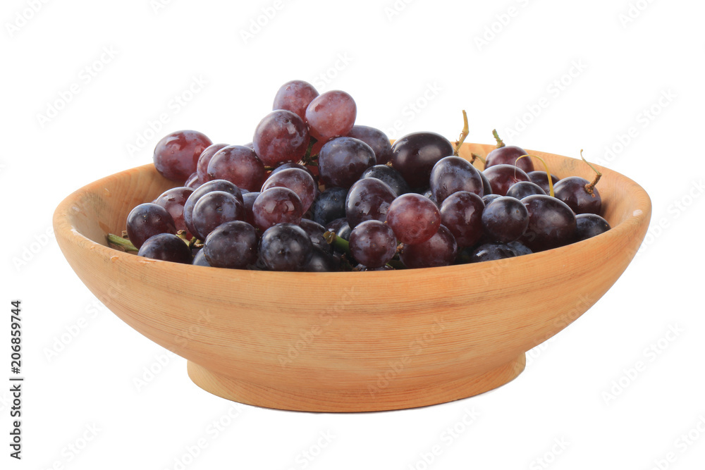 Fototapeta premium heap of red grapes in wooden cup isolated on white background