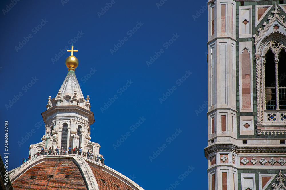 Close-up of people on the dome of the Santa Maria del Fiore Cathedral and Giotto's Campanile (bell tower). In Florence, the famous and amazing capital of the Italian Renaissance. Tuscany region