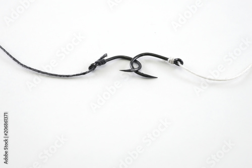 Fishing hook hooked with black and white rope hangs together on
