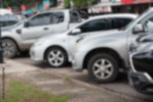 Cars parked along the road, walking, blurred. © kunpisit