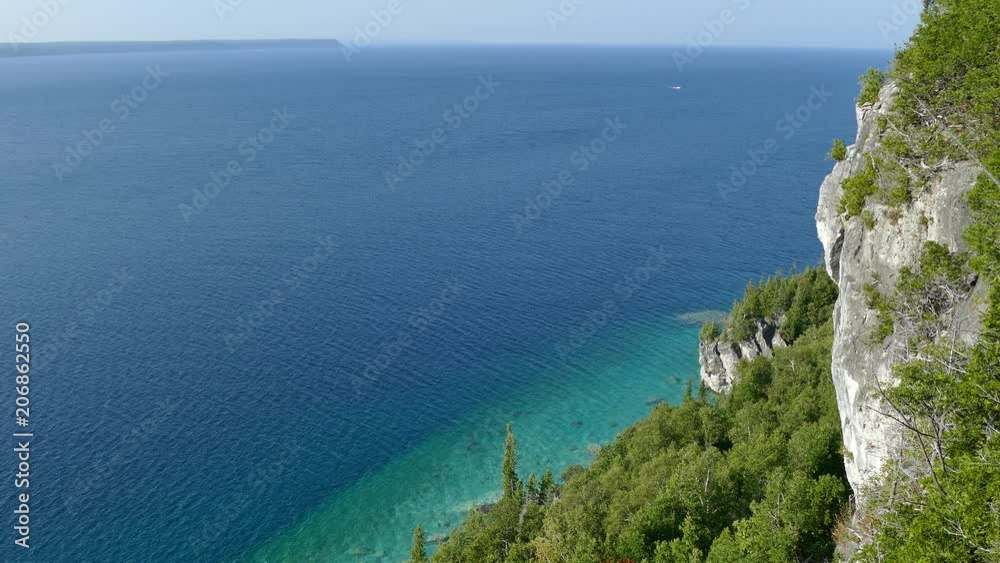 High altitude ocean cliff view of beautiful deep blue water on sunny day High altitude ocean cliff view of beautiful deep blue water on sunny day