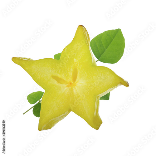 half of yellow carambola with green leaves isolated on white background