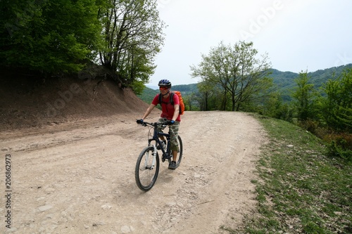 Cyclist rides on a dirt road in the mountains