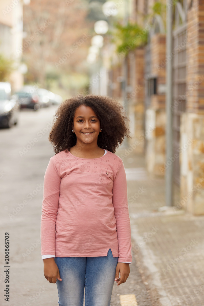 Cute African American girl in the street with afro hair