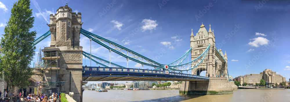 LONDON - JUNE 2015: Tourists near Tower Bridge. London attracts 20 million tourists annually