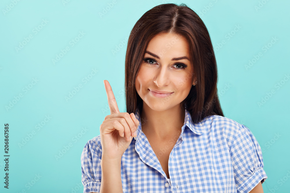 Woman against blue wall background