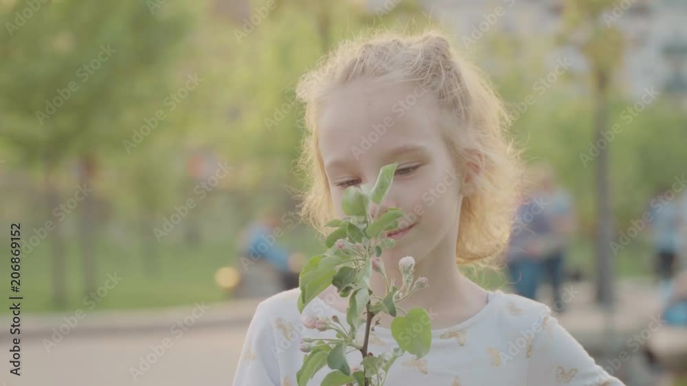 Portret of beautiful smiling girl in the park. Sun and nice nature. Slow motion Portret of beautiful smiling girl in the park. Sun and nice nature. Slow motion
