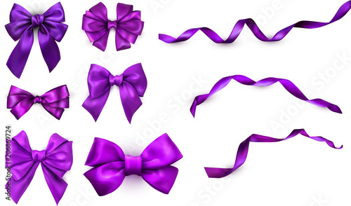 Purple realistic satin bows and ribbons isolated on white.