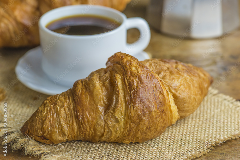Croissant and a cup of tea French breakfast, Stock image