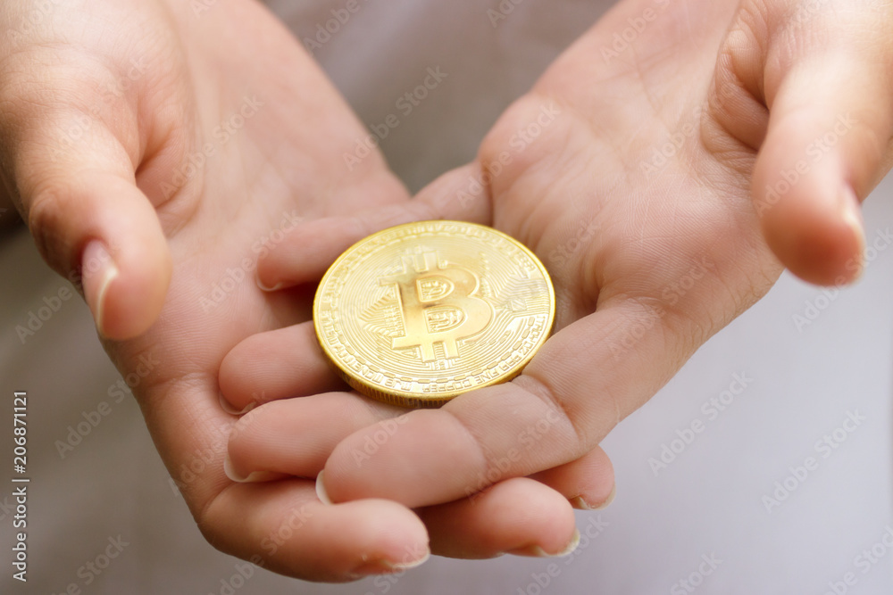 female hands closeup with the coin bitcoin female hands closeup with the coin bitcoin