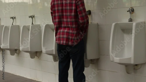 A man walking to Urinal for happy urine in the Toilet place concept.