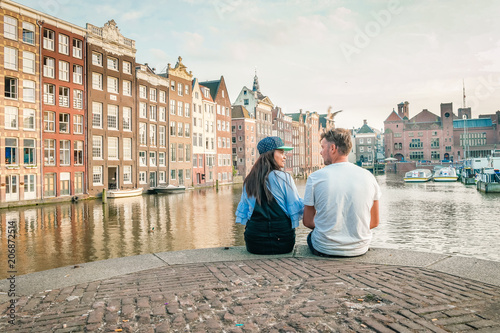 young couple at waterfront Amsterdam city trip Netherlands sunset summer
