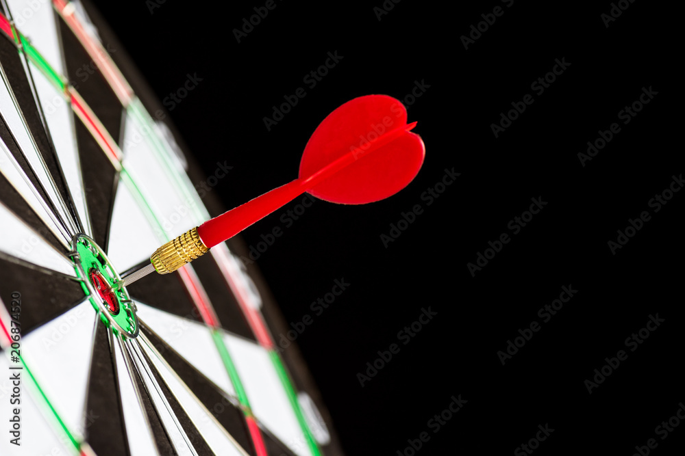 Close up shot red darts arrows in the target center on black background. Business target or goal success and winner concept. Close up shot red darts arrows in the target center on black background. Business target or goal success and winner concept.