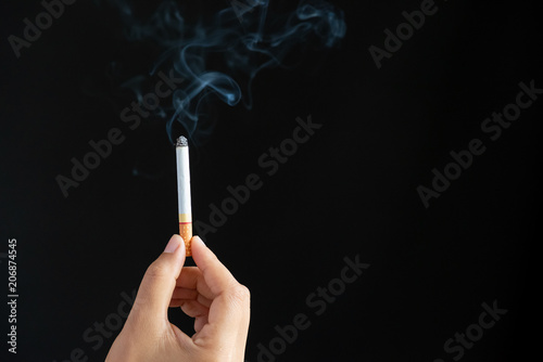 World No Tobacco Day, May 31. STOP Smoking. Close up Man hand holding cigarettes on black background.
