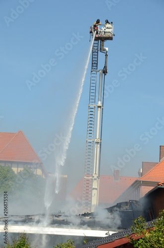 Fire in a building, firemen fight the fire from a lift. photo