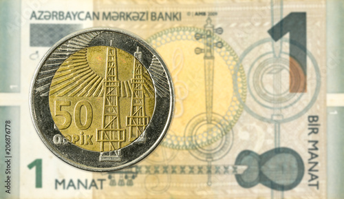 50 azerbaijani qepik coin against 1 azerbaijani manat bank note photo