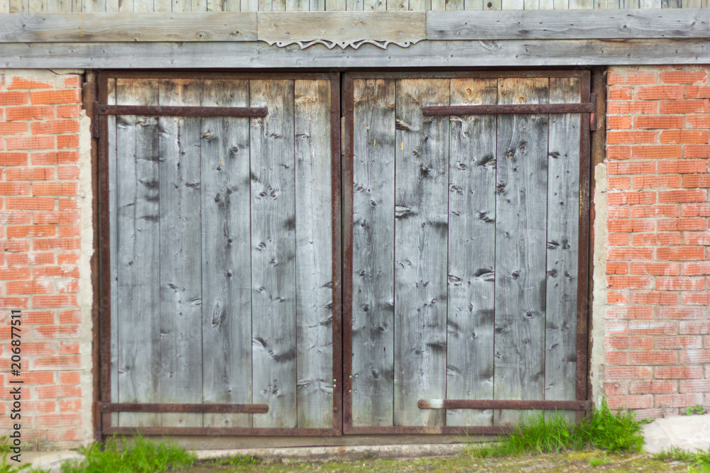 old wooden door in a brick garage old wooden door in a brick garage