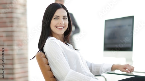 successful young business woman sitting at workplace