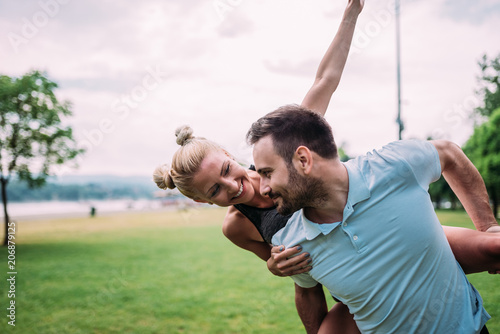 Young couple having fun in the city park.