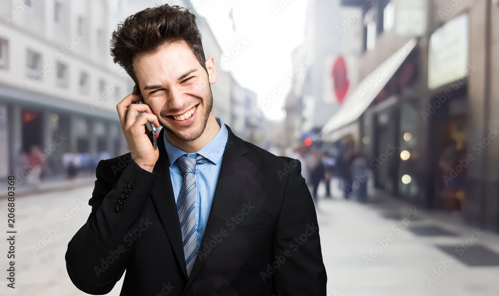 Smiling businessman talking on the phone Smiling businessman talking on the phone