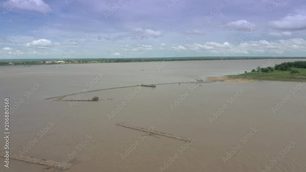 Aerial : fly towards workers are dismantling a part of the bamboo bridge. Turns out the river had risen and snapped the bridge. It had broken and separated. Aerial : fly towards workers are dismantling a part of the bamboo bridge. Turns out the river had risen and snapped the bridge. It had broken and separated.