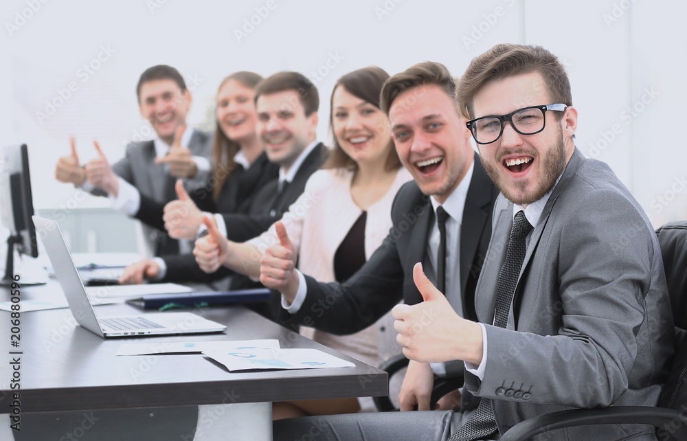 business team with thumbs up while sitting at his Desk business team with thumbs up while sitting at his Desk