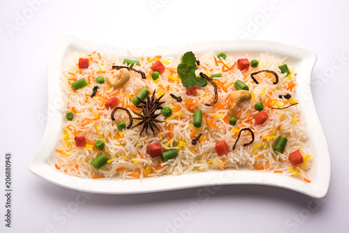 Indian Vegetable Pulav or Biryani made using Basmati Rice, served in a ceramic bowl. selective focus