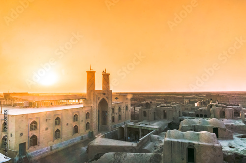 Sunset over mosque of Ghoortan citadell by village of Varzaneh - Iran photo